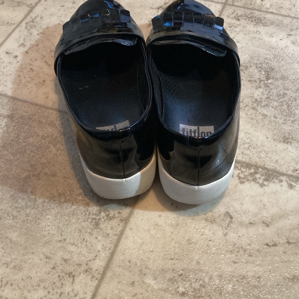Fit flip black shiny frilly loafers style black shed with small mark on one toe. - Picture 4 of 10